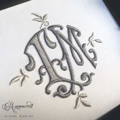 the monogrammed design on this handkerchief is very intricately detailed, and it looks to be hand embroidered