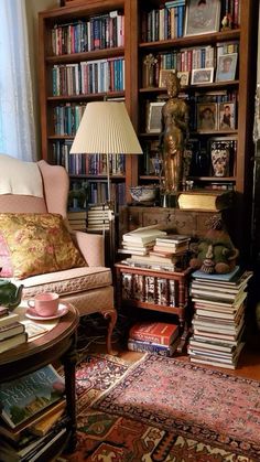 a living room filled with lots of books and furniture