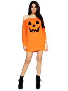 a woman in an orange shirt dress with a pumpkin face on the chest and black boots