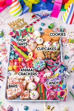 a box filled with lots of different types of candies and cookies on top of a table