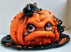 an orange halloween pumpkin with black spider webs on it's head and eyes