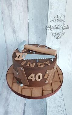 a birthday cake with a knife on top and the number forty written in wooden letters