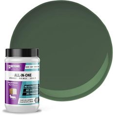 a bottle of green acrylone paint next to it's lid on a white background