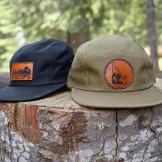 5-panel Camping Hat With Logo Patch, Outdoor Trucker Hat With Leather Patch And Short Brim, Flat Bill Hat With Logo Patch For Outdoor Activities, Outdoor Short Brim Hats With Logo Patch, Outdoor 5-panel Baseball Cap With Leather Patch, Leather Patch Cap For Outdoor Activities, Brown 5-panel Adventure Hat, Outdoor 5-panel Hat With Logo Patch, Flat Bill Hats Made In Usa For Outdoor