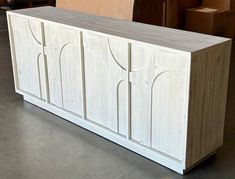 a large white cabinet sitting on top of a floor