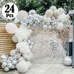 white and silver balloons are on display in front of a gate with the number 24 attached to it