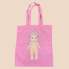 a pink tote bag with an image of a baby doll on it