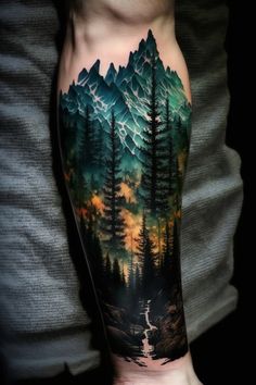 a man's arm with a forest and mountains tattoo on it