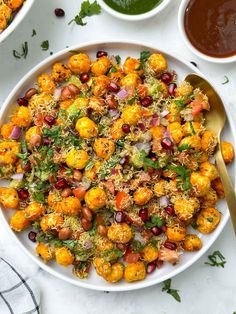 a white bowl filled with roasted cauliflower and broccoli sprinkled with pomegranates