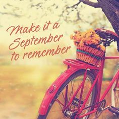 a red bicycle with flowers in the basket is parked next to a tree that reads make it a september to remember