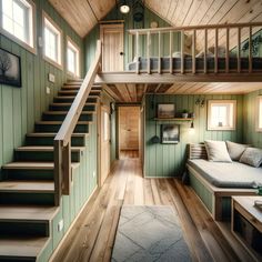 the interior of a tiny house with wood floors and green walls, stairs leading up to the second floor