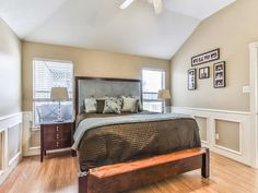 a bed sitting in the middle of a bedroom on top of a hard wood floor