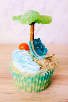 a cupcake with blue frosting and a tree on top