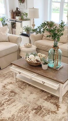 a living room with two couches and a coffee table in the middle of it