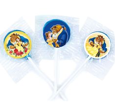 three lollipops shaped like disney princesses and the beast characters on them