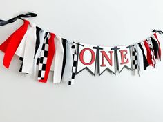 a banner with the word one hanging from it's side on a white wall