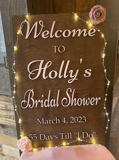 a wooden sign that says welcome to holly's bridal shower