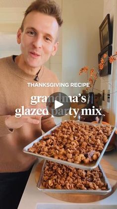 a man holding a tray of granola's glazed party mix