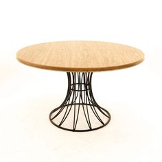 a round wooden table with metal base