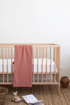 a baby crib with an open book on the floor