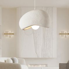 a living room with white furniture and lights