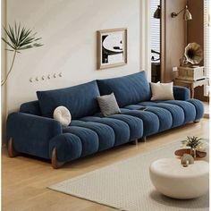 a living room with a blue couch and white rug