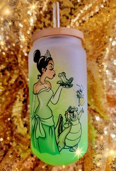 a green and white cup with an image of princess on it