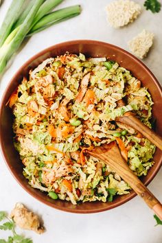 a wooden bowl filled with rice and vegetables