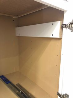 the inside of a storage room with no doors or drawers on one side and an opening in the other