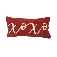 a red and white pillow with the word koro on it's front side