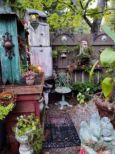 an outdoor garden with lots of potted plants and other things in the area around it