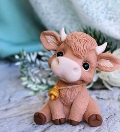 a brown cow figurine sitting on top of a table