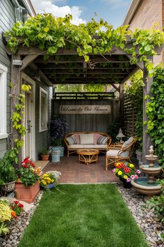 Cozy patio with a pergola covered in greenery, seating area, "Welcome to Our Haven" sign, and colorful flowers. Small Outside Garden Ideas, Small Backyard Ideas No Grass Spaces, Backyard Garden Small Spaces, Small Front Yard Seating Area Ideas, Simple Backyard Design Ideas, Simple Small Patio Ideas, Small Urban Backyard Ideas, Small Backyard Renovations