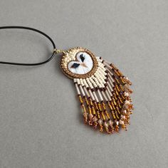 a beaded owl pendant on a black cord