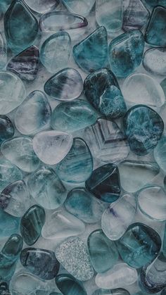 blue and white glass pebbles are arranged together