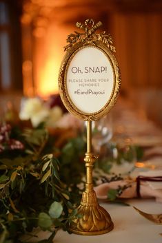 a table topped with a sign and flowers