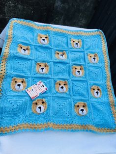 a crocheted blanket with teddy bears on it