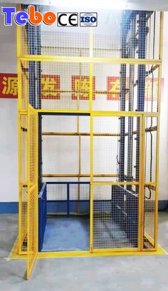 a large yellow cage in the middle of a room