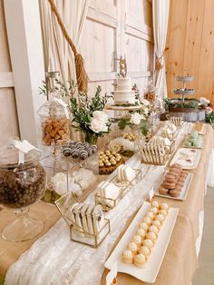 a table topped with lots of desserts and pastries