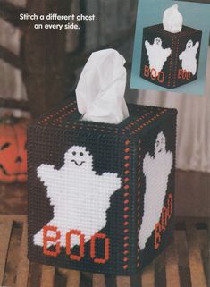 an image of a halloween tissue box with ghostes on it and the words boo written in white