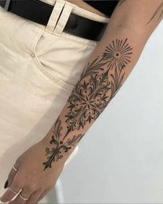 a woman's arm with a tattoo on it that has an intricate design in the middle