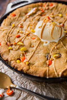 a cookie with ice cream and candy on top