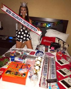 a woman wearing a tiara is sitting on a bed surrounded by items from her personal collection