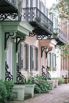 an old house with balconys and balconies on the second floor is painted green