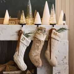 christmas stockings hanging from a fireplace mantel