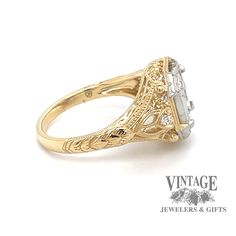 an antique style engagement ring with filigrees and diamonds