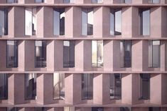 the facade of an office building with many windows and balconies on each side