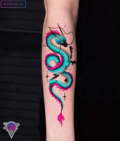 a blue and pink dragon tattoo on the arm