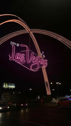 the city of las vegas sign is lit up at night with lights in the background