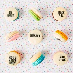 macaroons with words written on them are arranged in the shape of small cookies